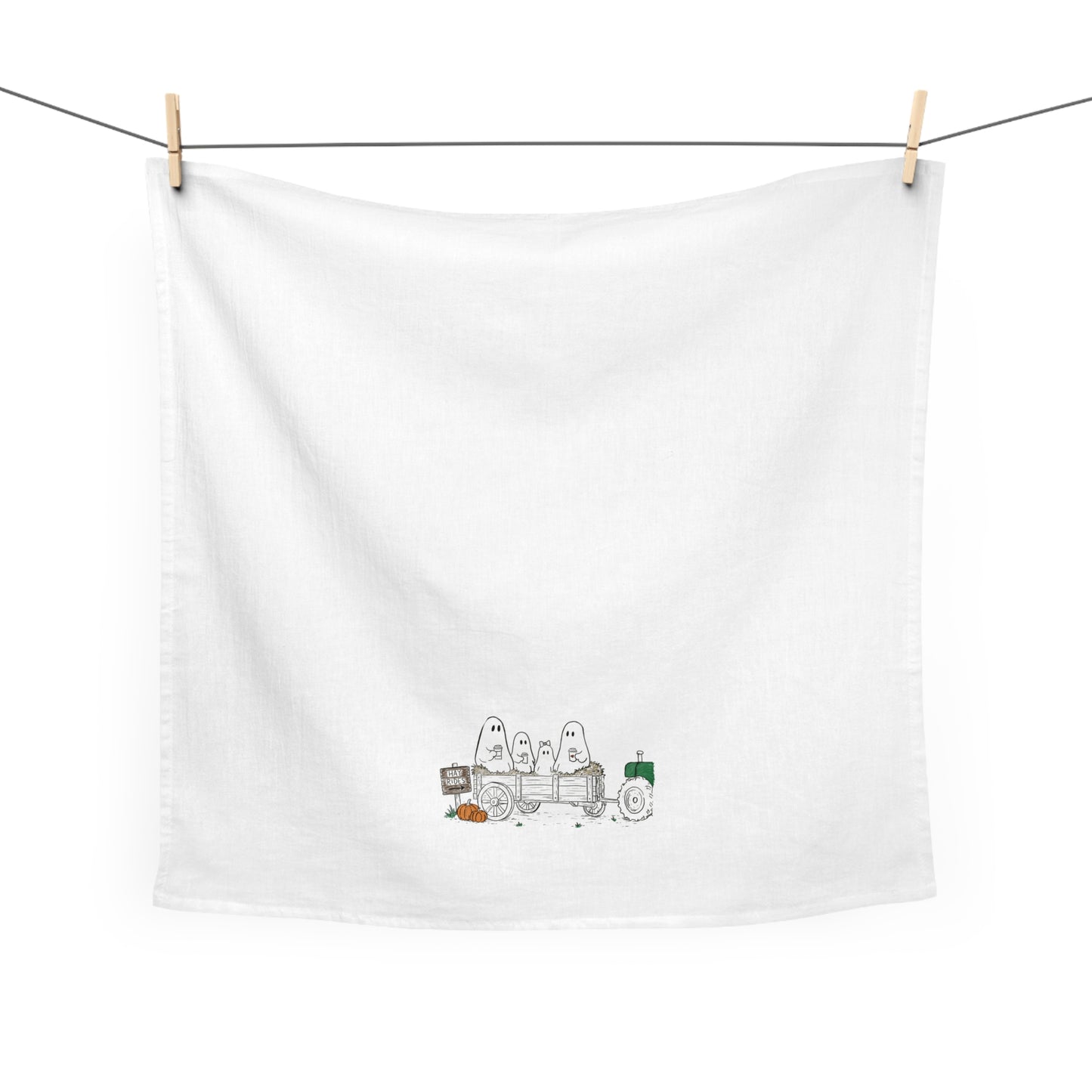 Hand-drawn ghost family riding on a fall hayride with pumpkins on a farmhouse tea towel.