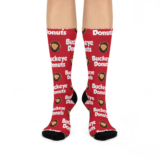 A pair of red cushioned crew socks with 'BUCKEYE DONUTS' text and logo pattern.