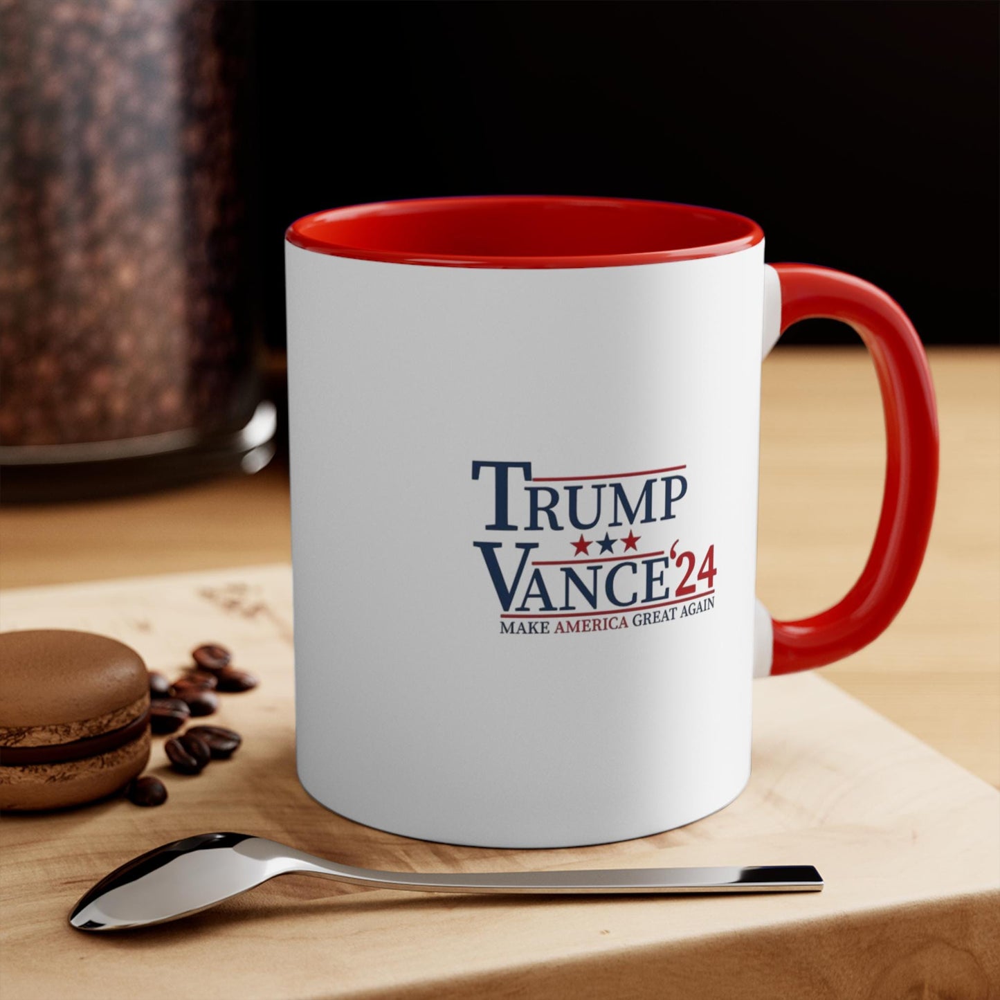 A white ceramic coffee mug with a bold red interior and handle, featuring the Trump Vance 2024 campaign logo.