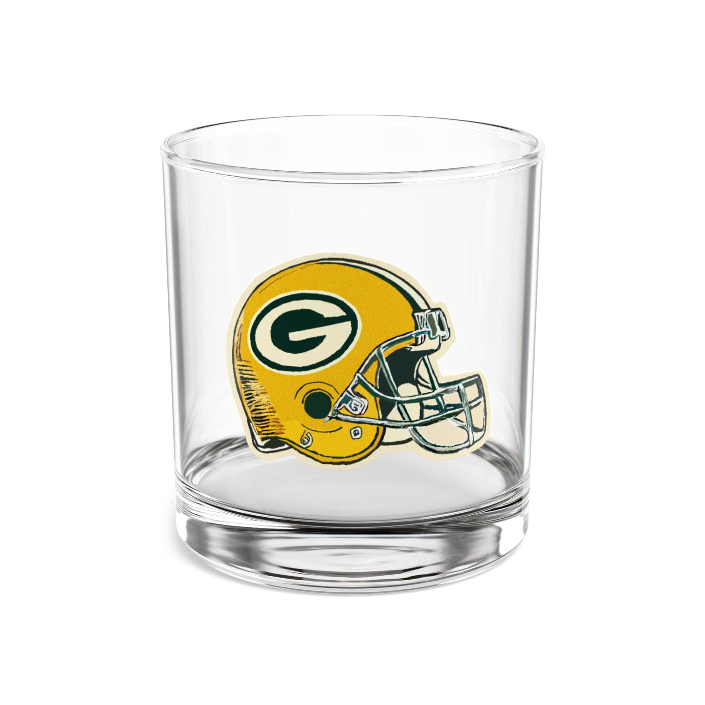 A clear glass rocks glass with a hand-drawn illustration of a Green Bay Packers football helmet design.