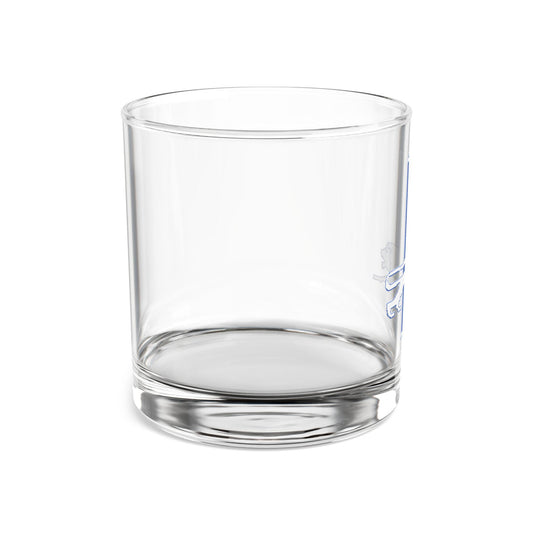 A clear rocks glass with a hand-drawn leaping lion design in blue and silver colors, representing the Detroit Lions.