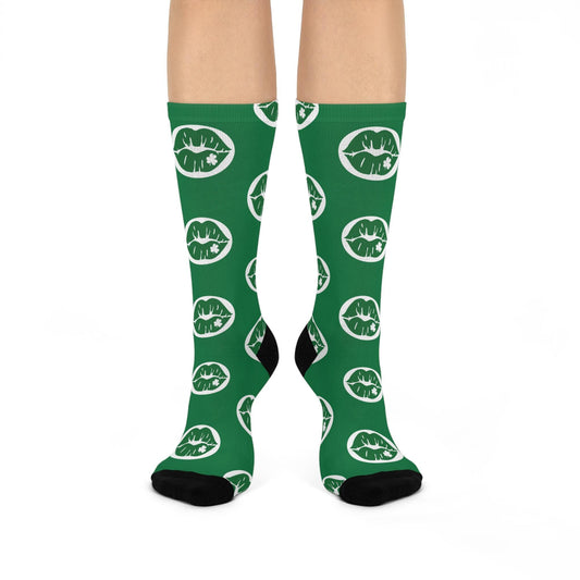 Green socks with white lip prints on a white background