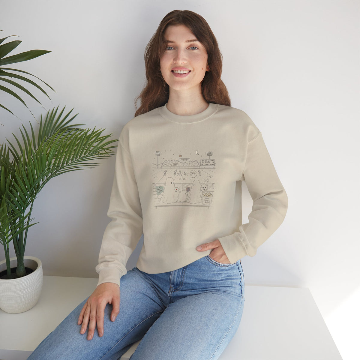 Cream crewneck sweatshirt featuring original cute ghost family football artwork from Friday Night Lights, Chapter 5 of The Story of the Ghost by Market Mafia Creations.