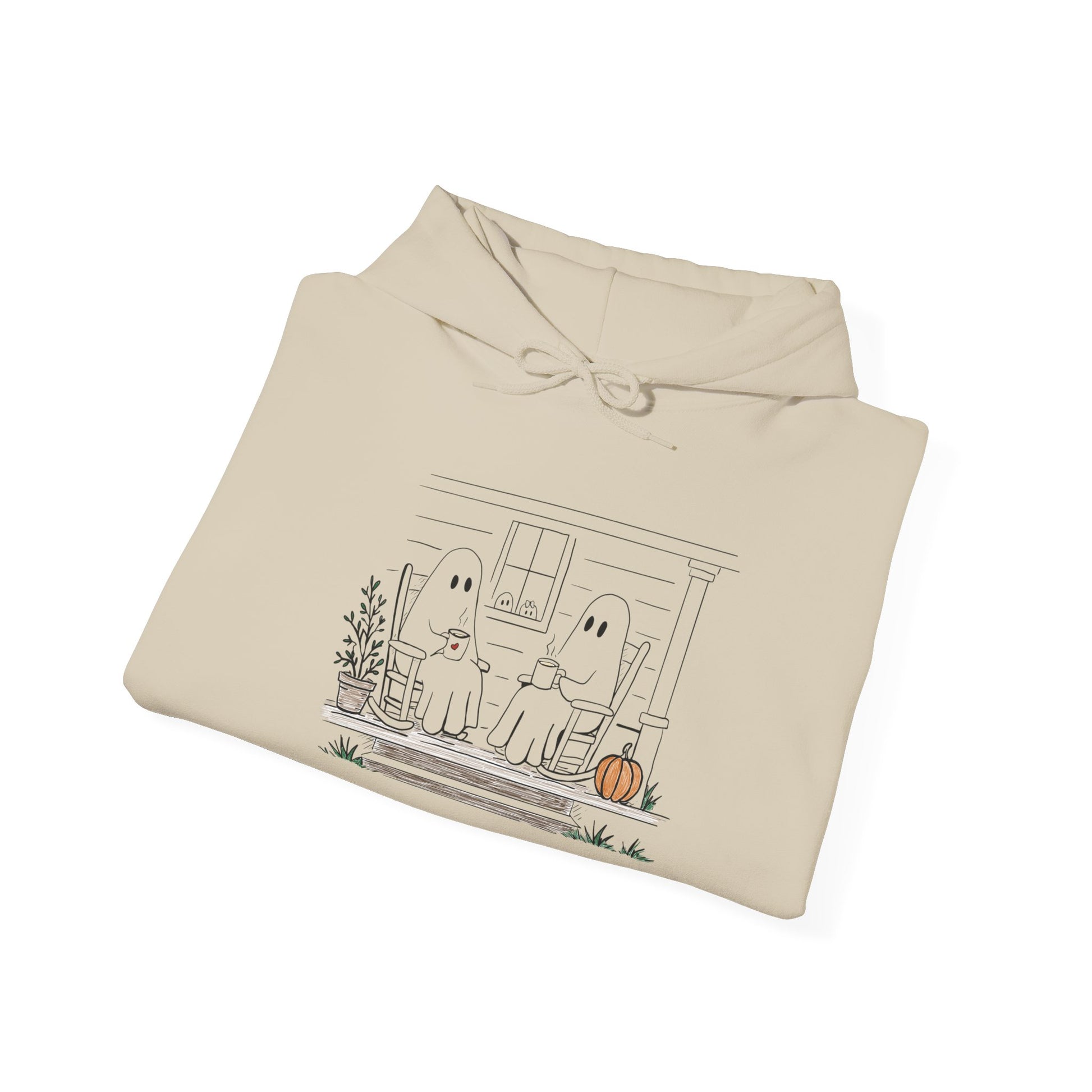 Pullover hoodie featuring a hand-drawn ghost family enjoying coffee in rocking chairs on a front porch, with two little ghosts peeking through the window, a pumpkin, and subtle fall color accents.