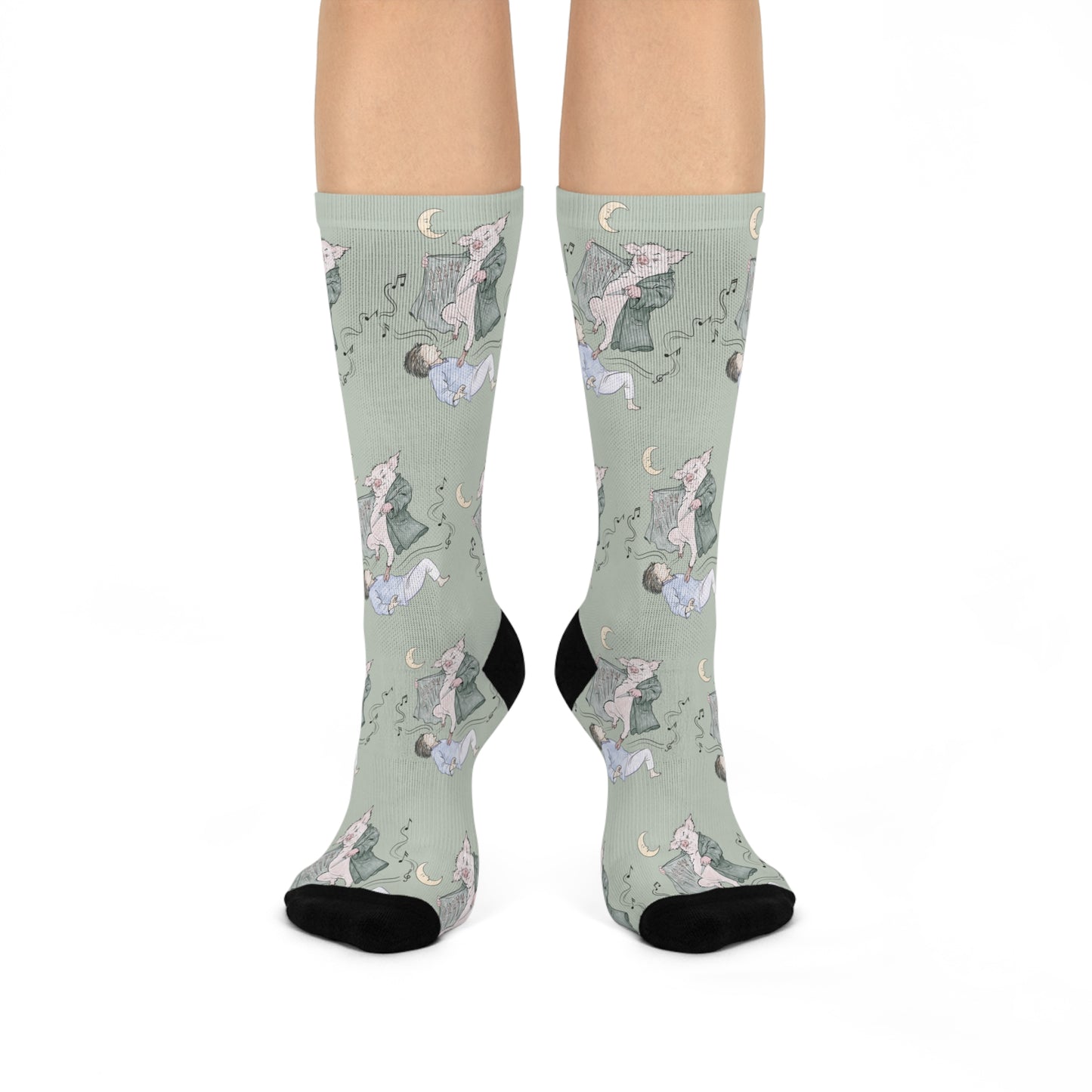 Pair of Guyute-inspired socks featuring original hand-drawn artwork with a surreal pig, moon, musical mist, and muted storybook colors.
