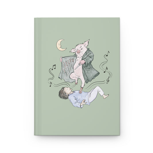 Hardcover journal featuring original hand-drawn Guyute-inspired artwork with a surreal pig, musical mist, moon, and muted storybook colors.