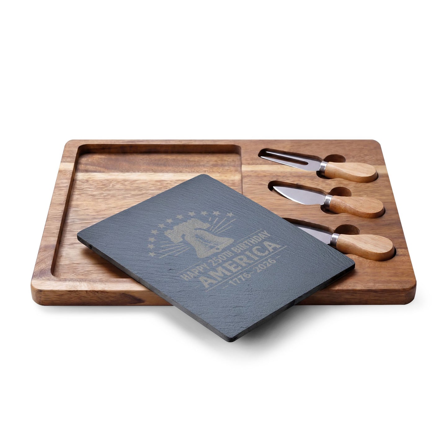 Wooden cutting board with cheese knives and a black slate board on a white background