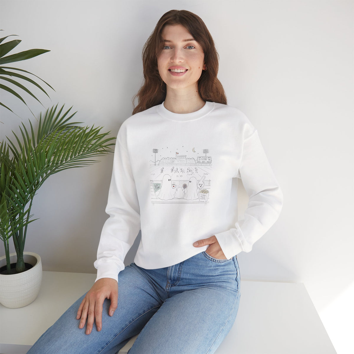 White crewneck sweatshirt featuring original cute ghost family football artwork from Friday Night Lights, Chapter 5 of The Story of the Ghost by Market Mafia Creations.