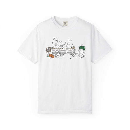 Comfort Colors white t-shirt featuring a hand-drawn ghost family riding in a hay wagon with pumpkins, coffee mugs, and a vintage tractor from The Story of the Ghost Chapter 1 collection.