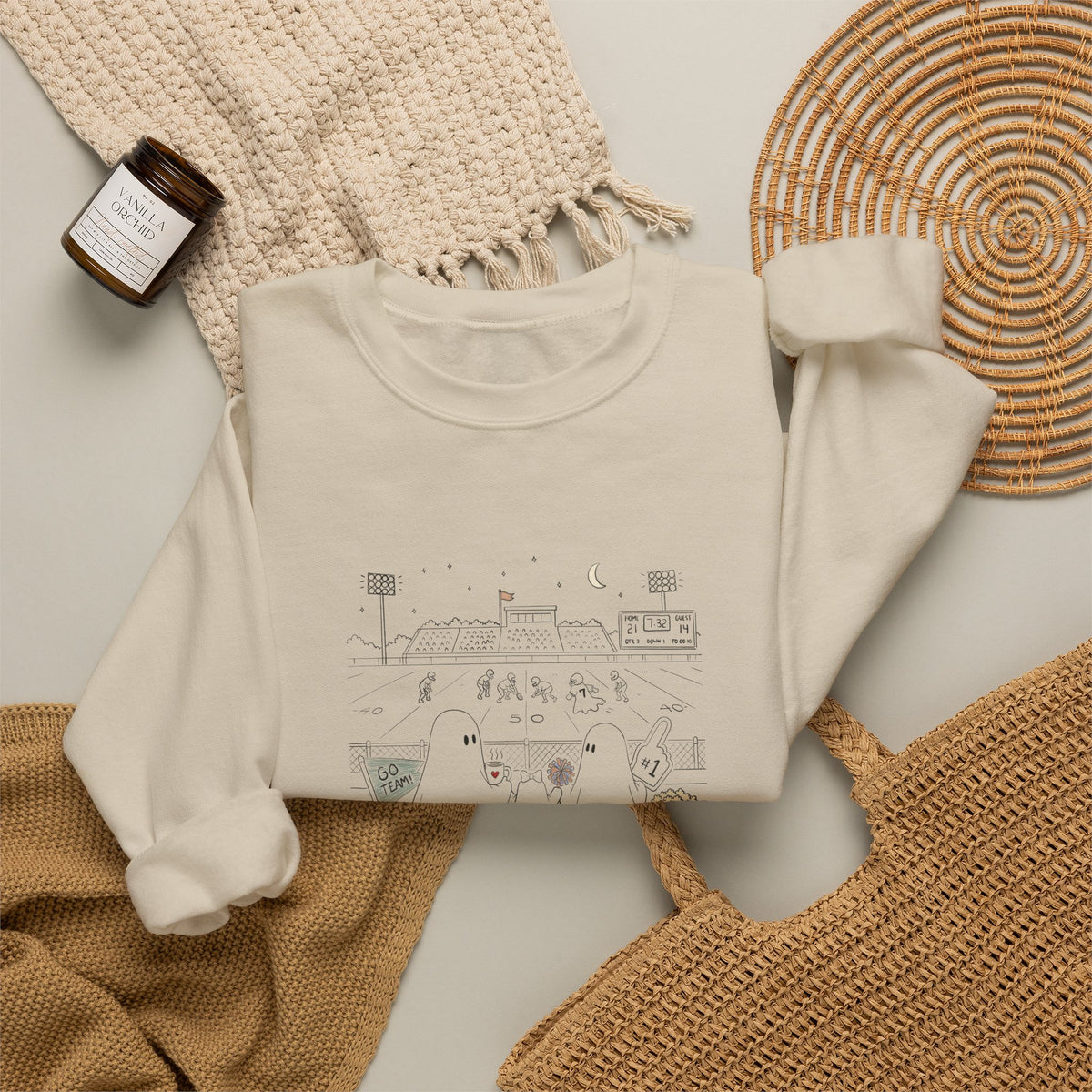 Cream crewneck sweatshirt featuring original cute ghost family football artwork from Friday Night Lights, Chapter 5 of The Story of the Ghost by Market Mafia Creations.