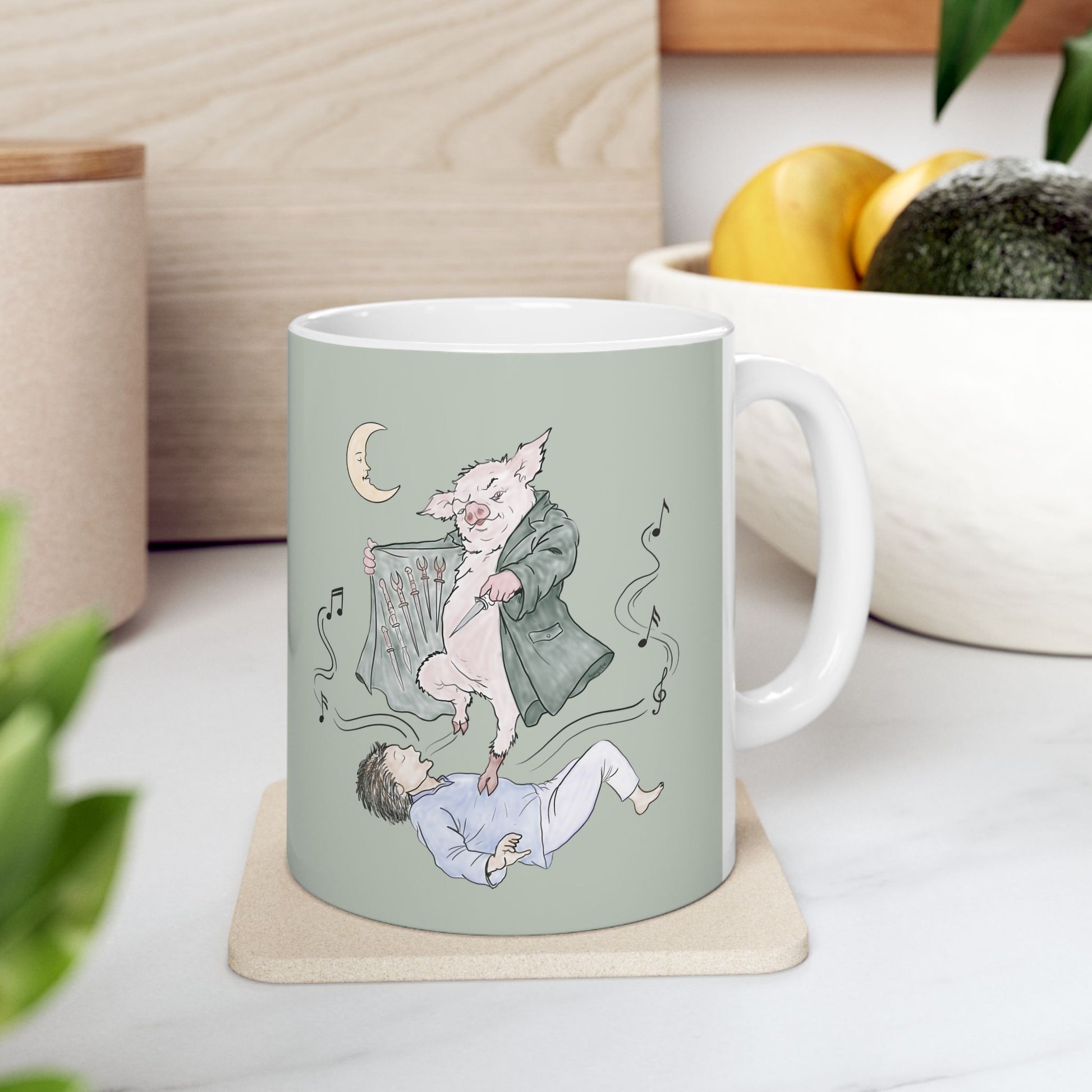 Sage green ceramic mug featuring original hand-drawn Guyute-inspired artwork with a surreal pig, musical mist, moon, and hidden song details.