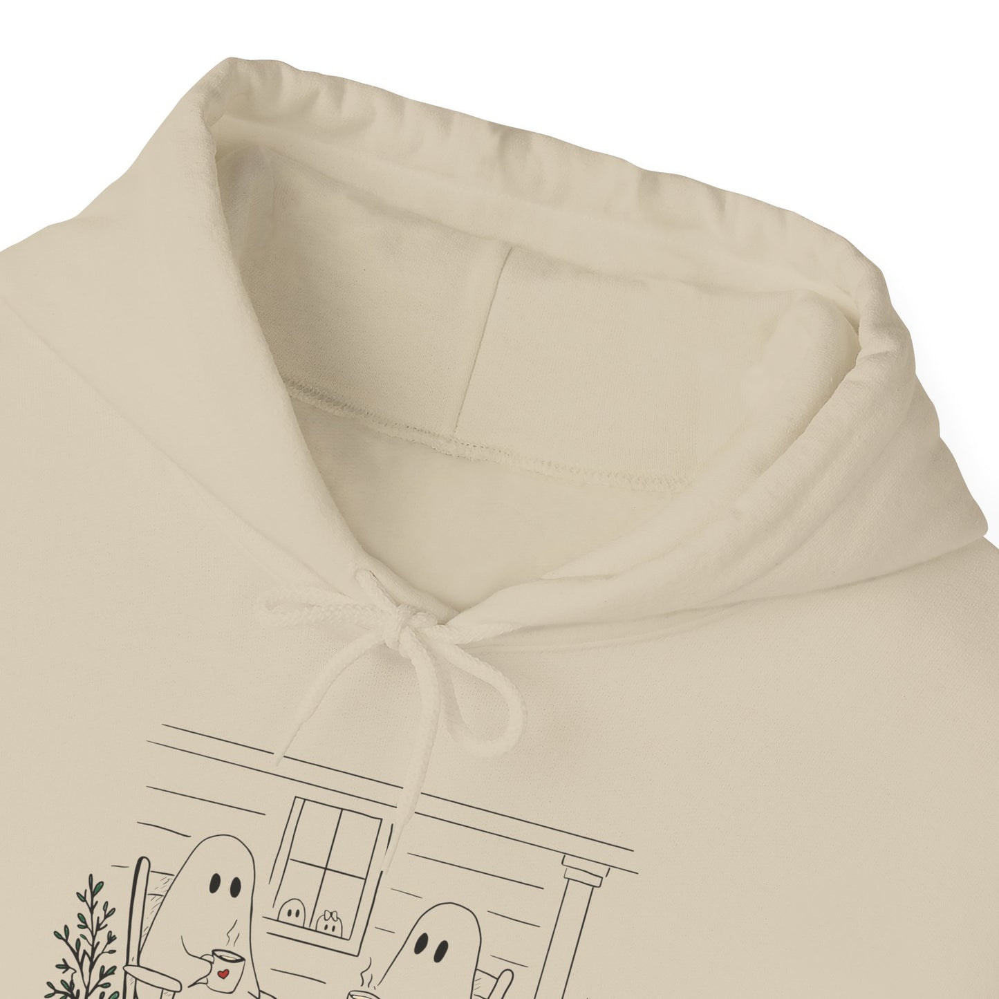 Pullover hoodie featuring a hand-drawn ghost family enjoying coffee in rocking chairs on a front porch, with two little ghosts peeking through the window, a pumpkin, and subtle fall color accents.