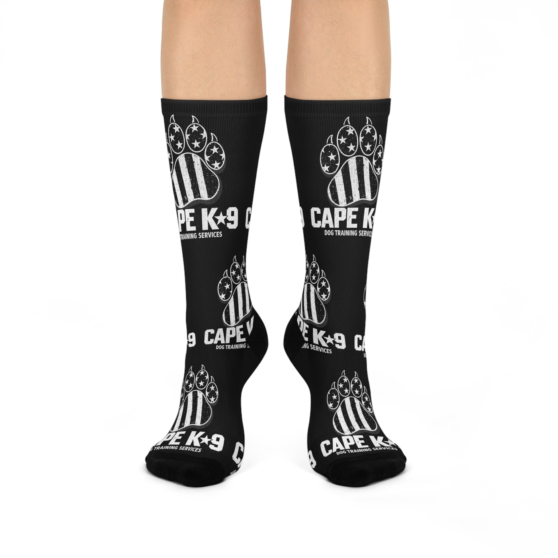 Black socks with 'CAPE K9' logo worn by a person on a white background