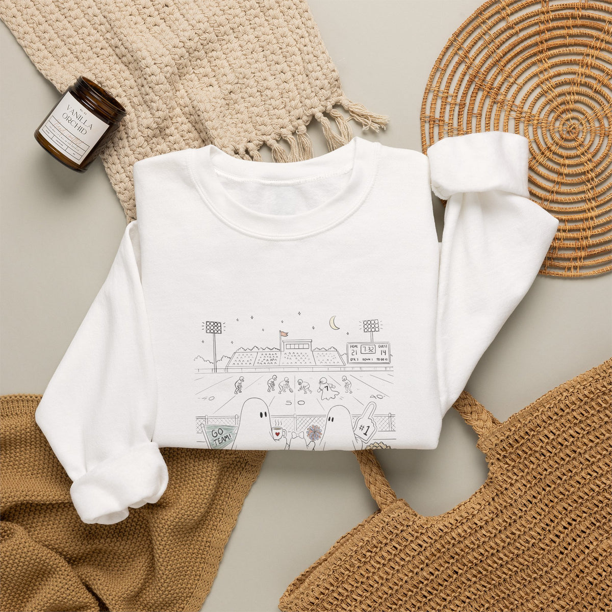 White crewneck sweatshirt featuring original cute ghost family football artwork from Friday Night Lights, Chapter 5 of The Story of the Ghost by Market Mafia Creations.