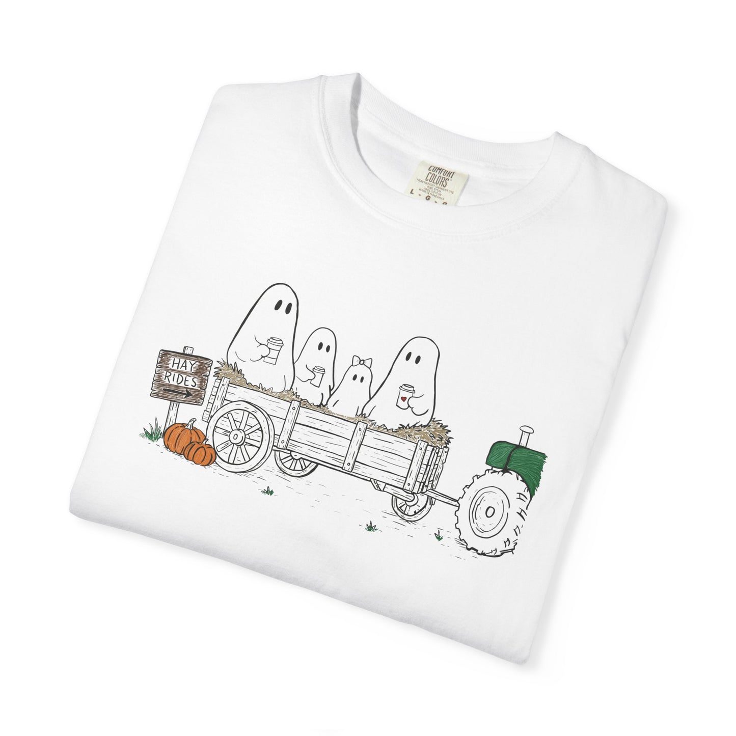 Comfort Colors white t-shirt featuring a hand-drawn ghost family riding in a hay wagon with pumpkins, coffee mugs, and a vintage tractor from The Story of the Ghost Chapter 1 collection.