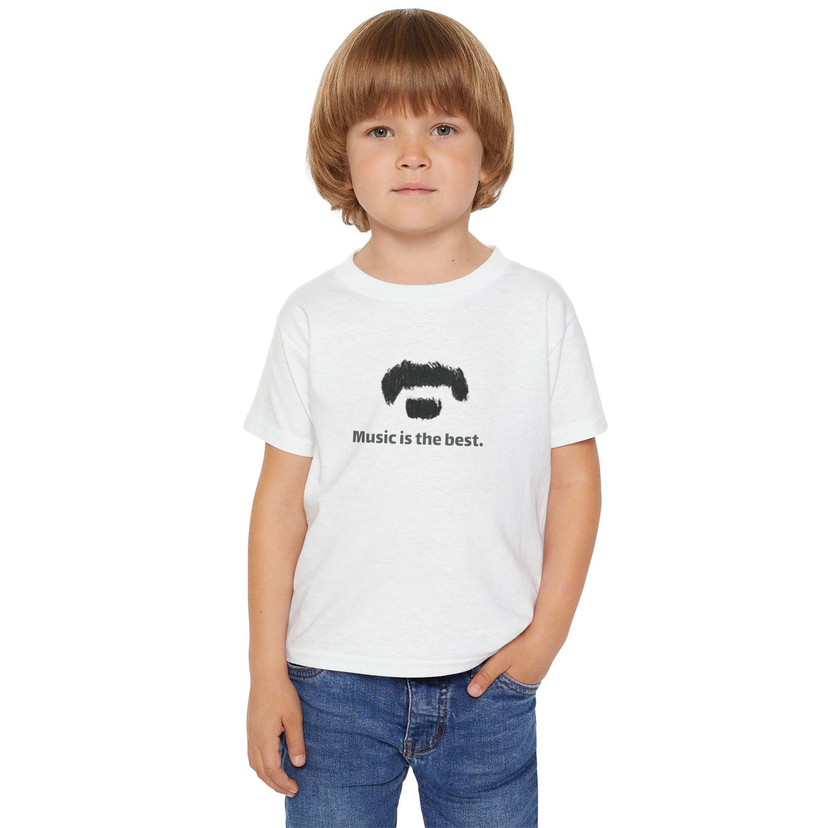 A young boy with light brown hair wearing a white crewneck t-shirt with the text 'music is the best' printed in black across the chest, paired with blue jeans, set against a plain white background.