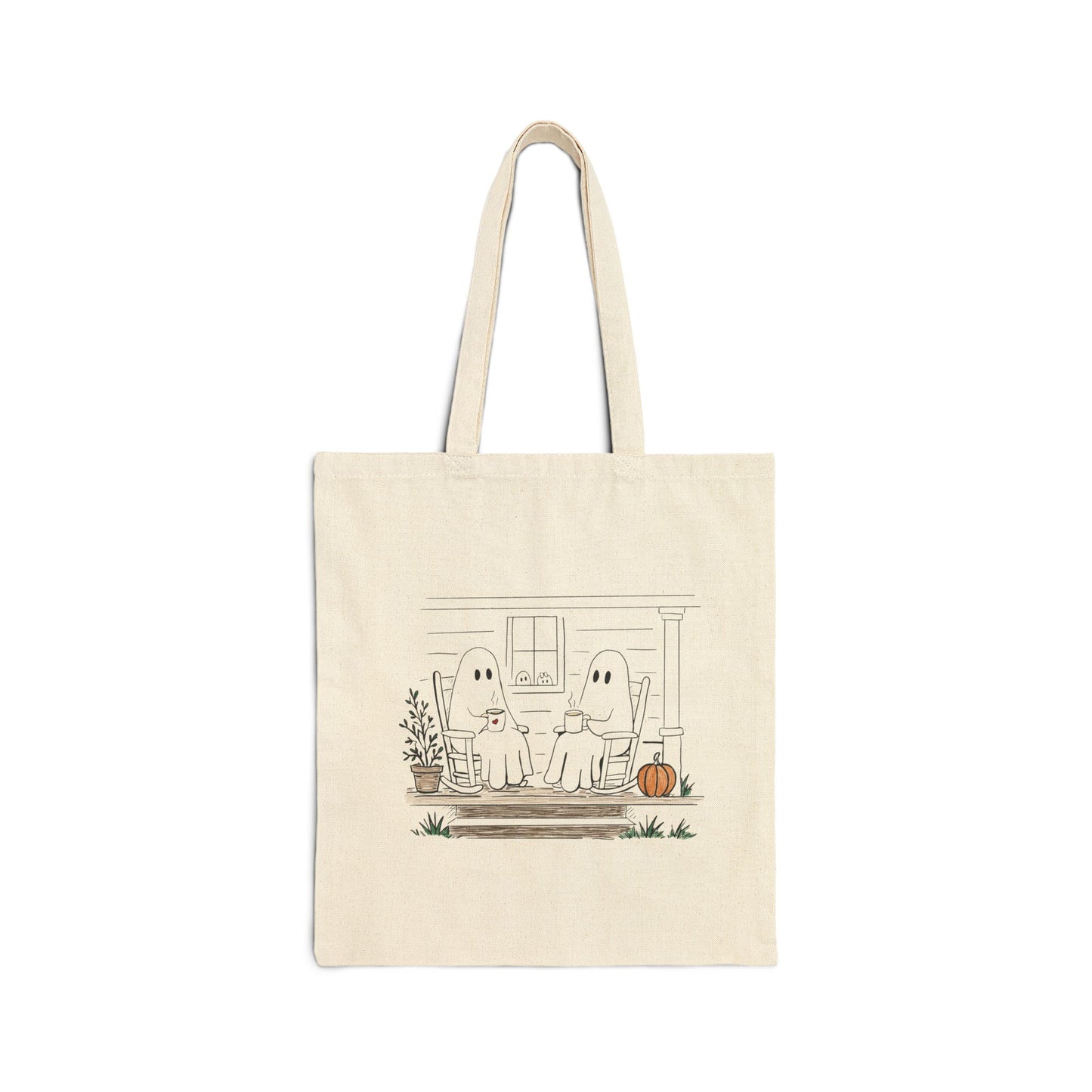 Natural canvas tote bag featuring a hand-drawn ghost family relaxing with coffee in rocking chairs on a front porch, with two little ghosts peeking through the window, a pumpkin, and subtle fall accents.