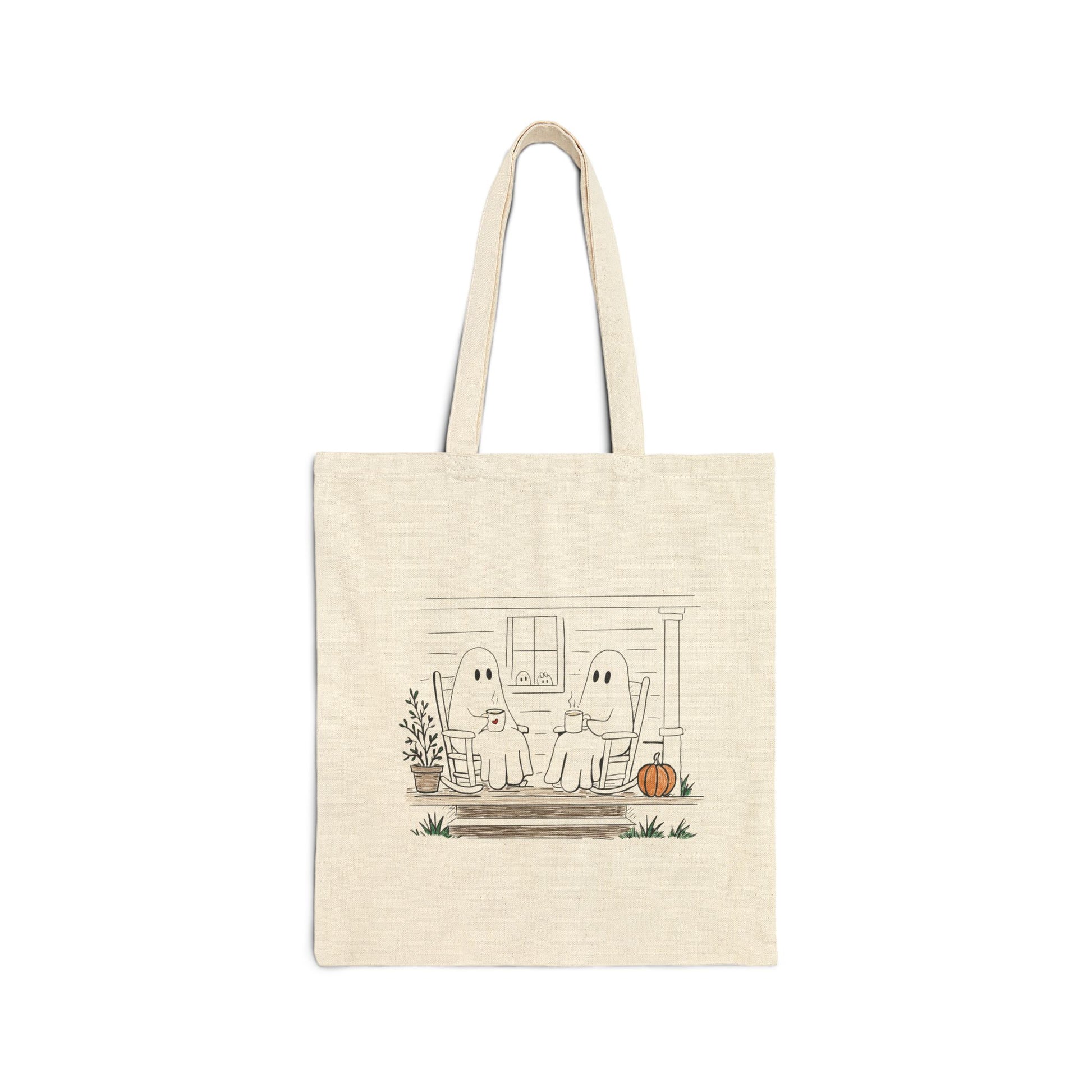 Natural canvas tote bag featuring a hand-drawn ghost family relaxing with coffee in rocking chairs on a front porch, with two little ghosts peeking through the window, a pumpkin, and subtle fall accents.