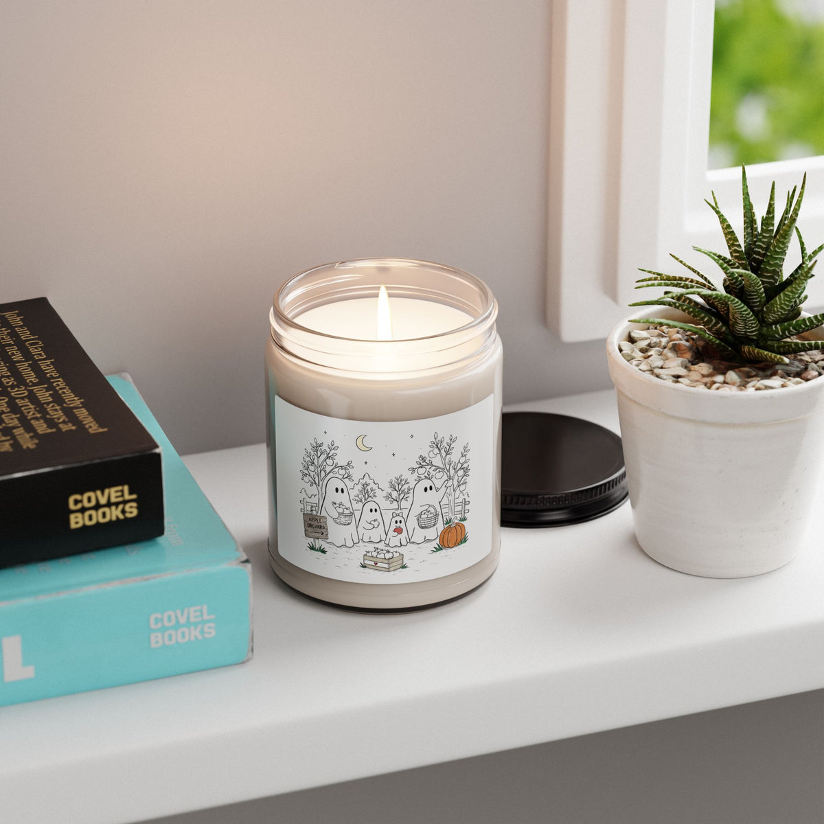 Apple Harvest soy candle featuring the ghost family picking apples in the Apple Orchard artwork from Chapter 4 of The Story of the Ghost.
