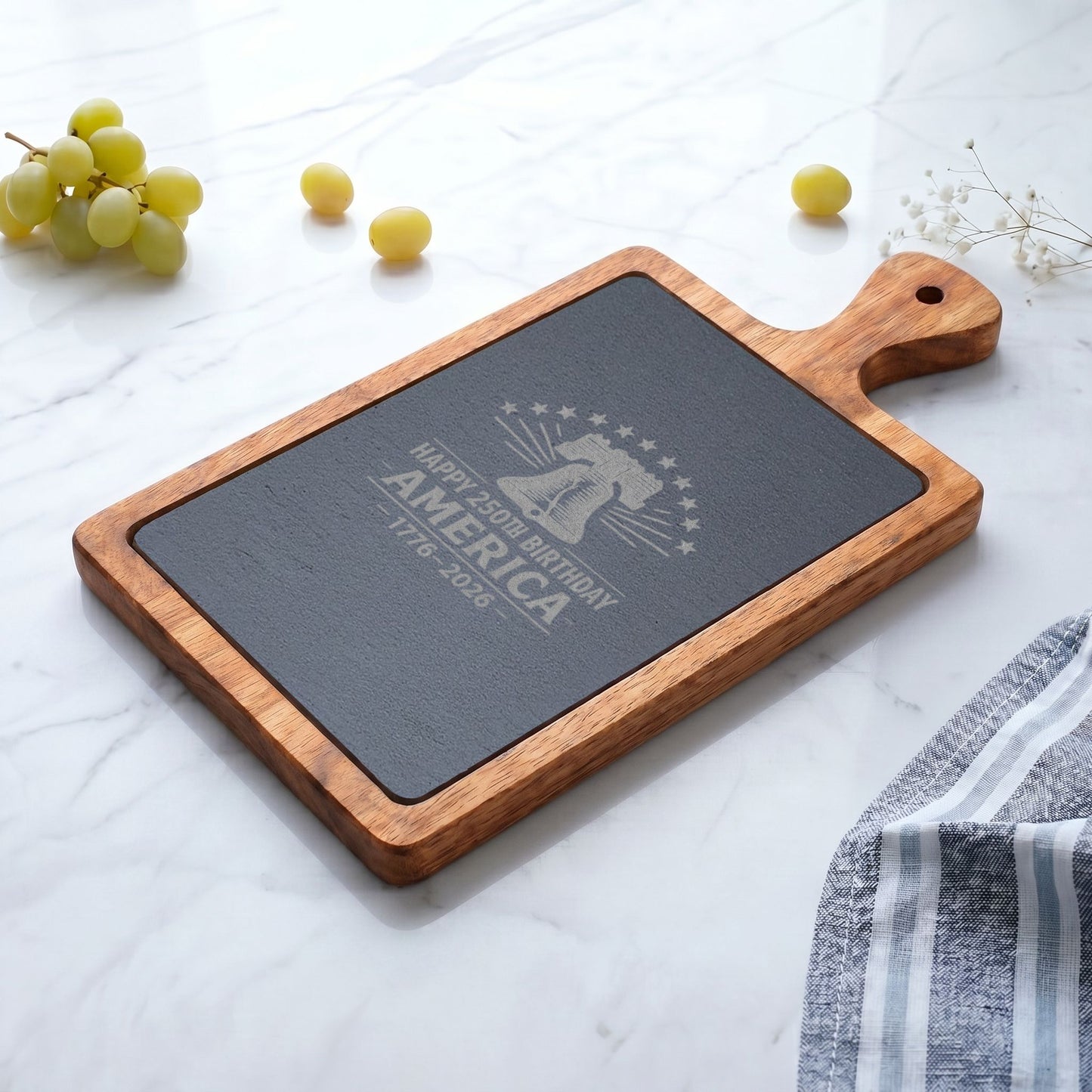 Acacia wood charcuterie board with engraved slate featuring a Liberty Bell and “Happy 250th Birthday America 1776-2026” patriotic design.