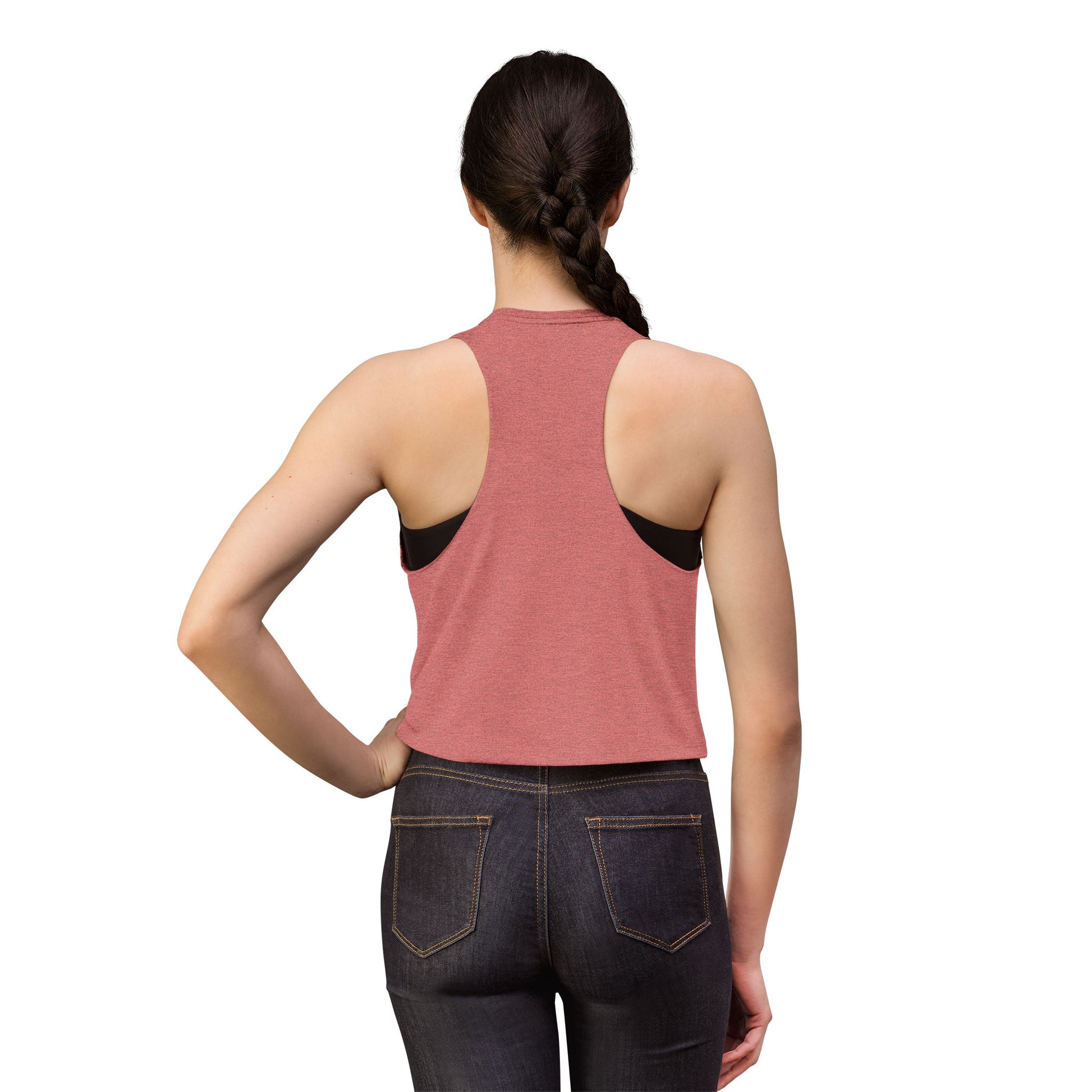Person wearing a pink tank top and dark jeans on a white background