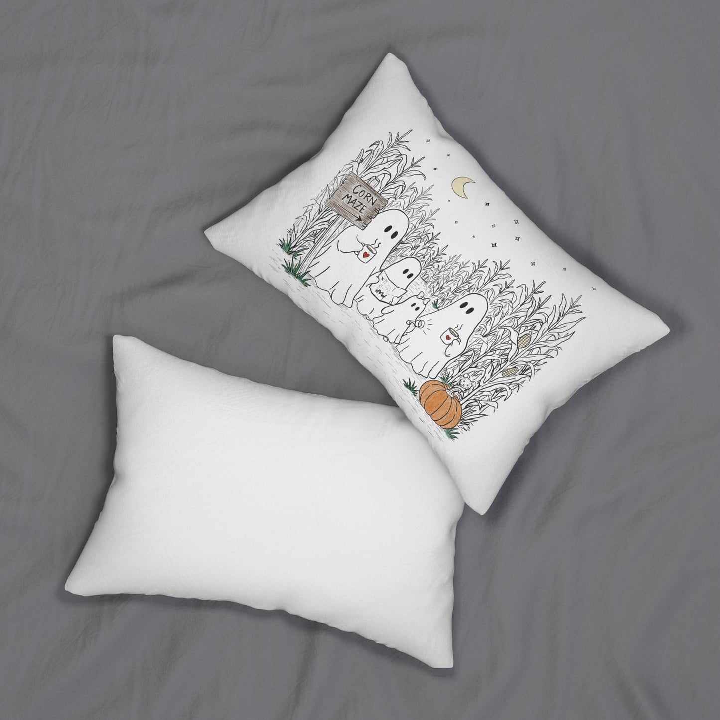 Rectangular lumbar pillow featuring a hand-drawn ghost family walking through a moonlit corn maze with warm drinks, tall corn stalks, and a pumpkin from The Story of the Ghost Chapter 2 collection.