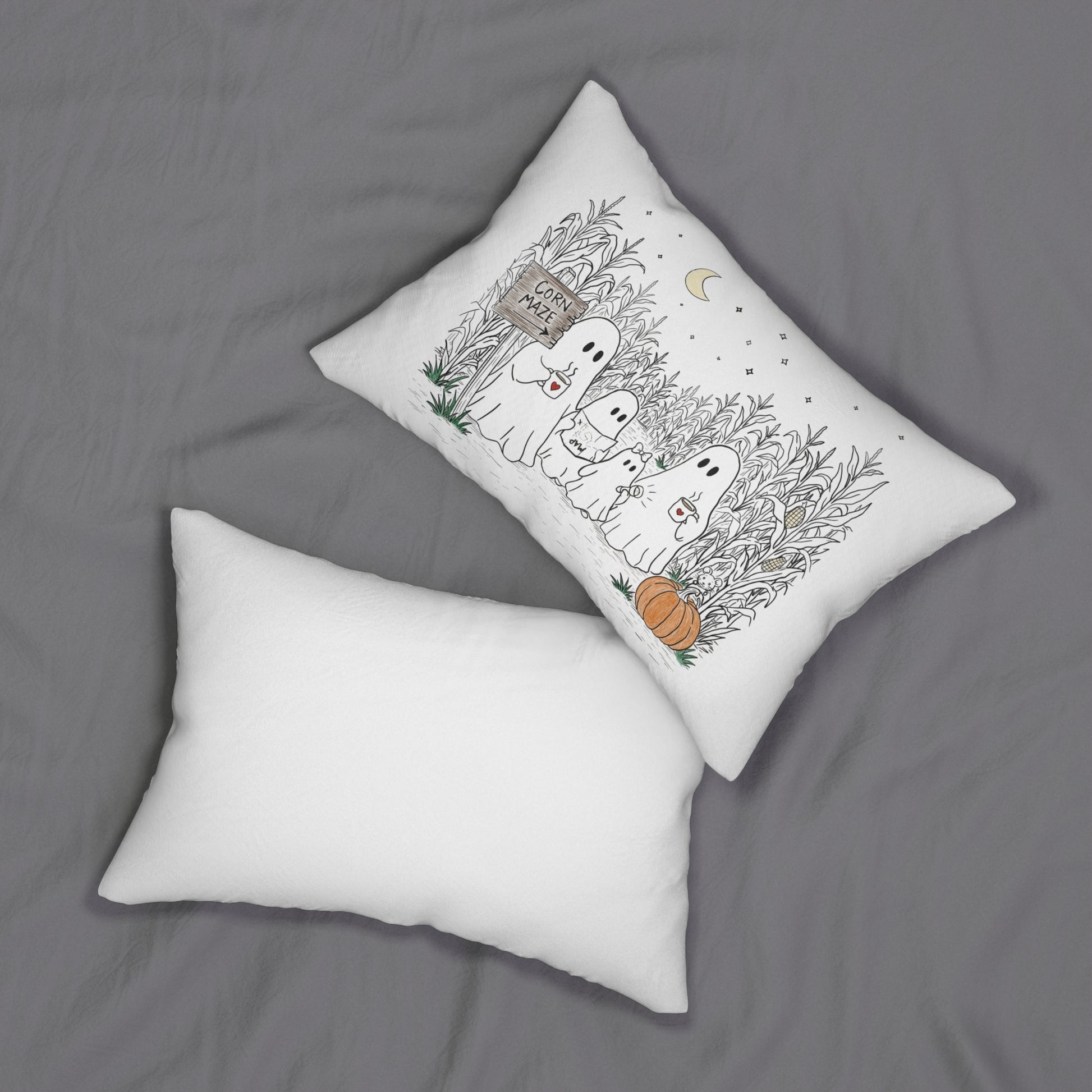 Rectangular lumbar pillow featuring a hand-drawn ghost family walking through a moonlit corn maze with warm drinks, tall corn stalks, and a pumpkin from The Story of the Ghost Chapter 2 collection.