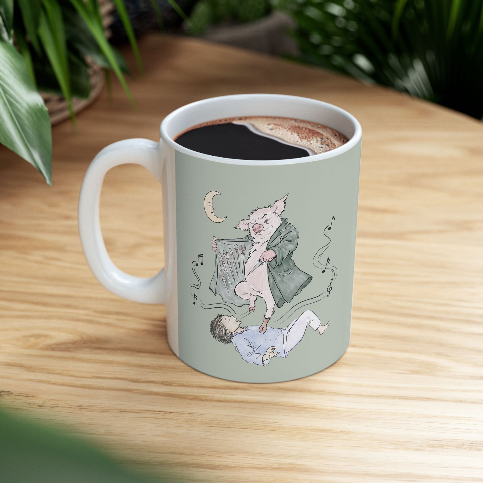 Sage green ceramic mug featuring original hand-drawn Guyute-inspired artwork with a surreal pig, musical mist, moon, and hidden song details.