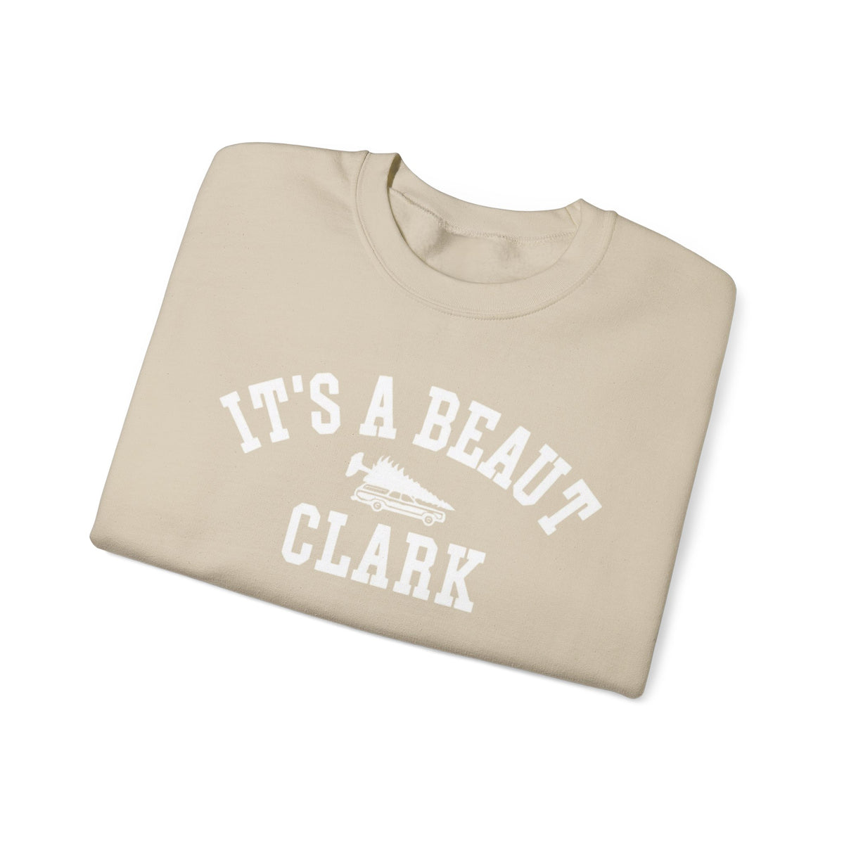 A sand color folded crewneck t-shirt with 'IT'S A BEAUT CLARK' and a graphic printed in white on the front, displayed on a clean white background.