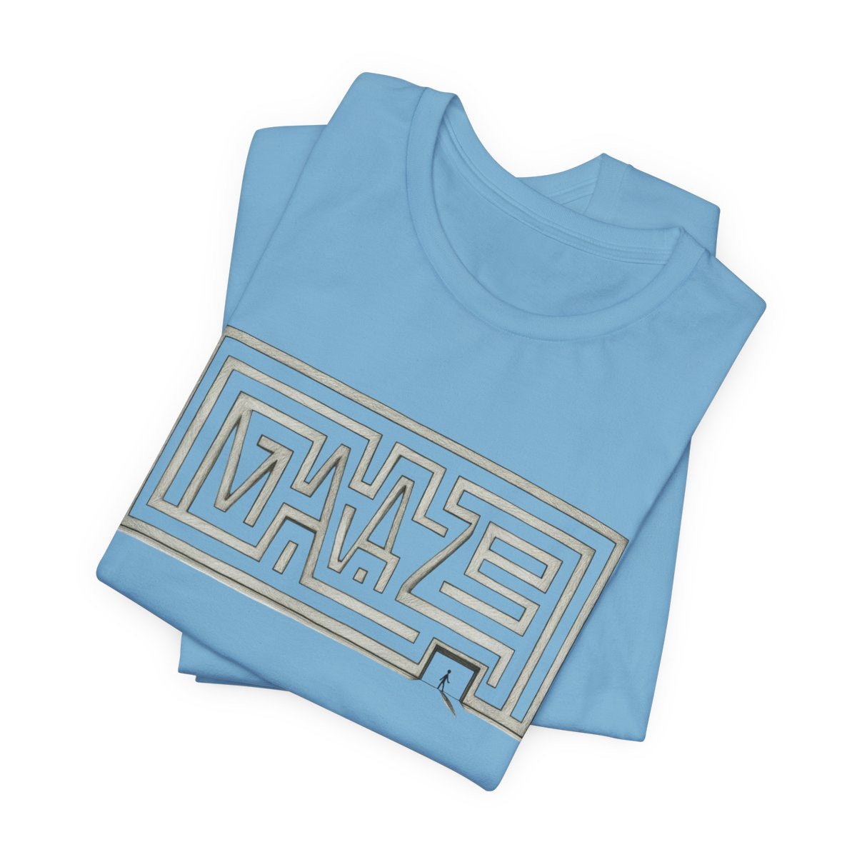 A folded light blue t-shirt with a large maze graphic printed on the front, set against a plain white background.