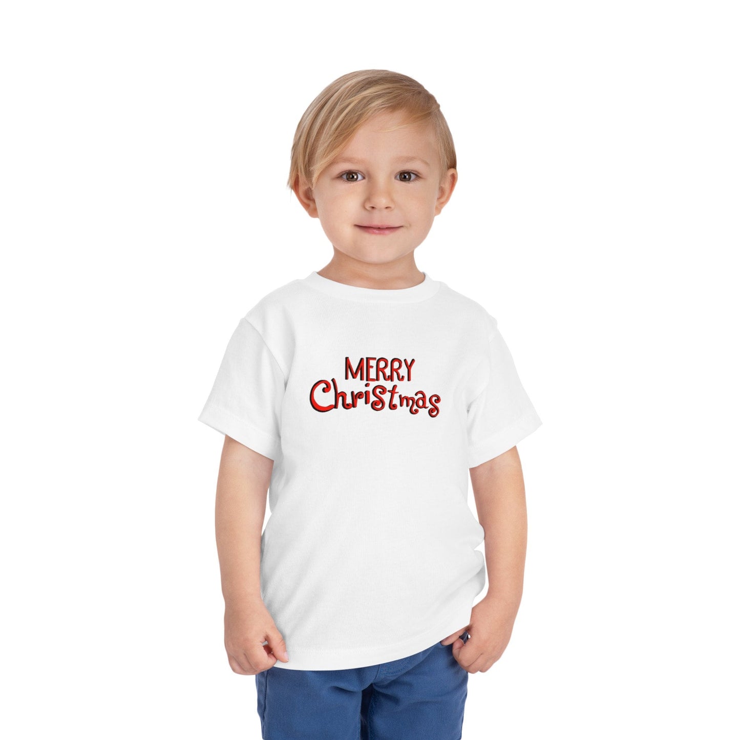A toddler wearing a white short sleeve tee shirt with the text 'Merry Christmas' printed on the front.