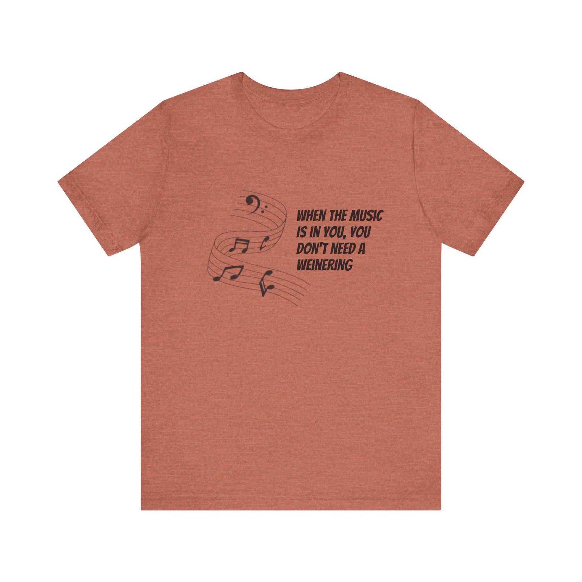 A pink t-shirt with a music-related quote written on the front in black.