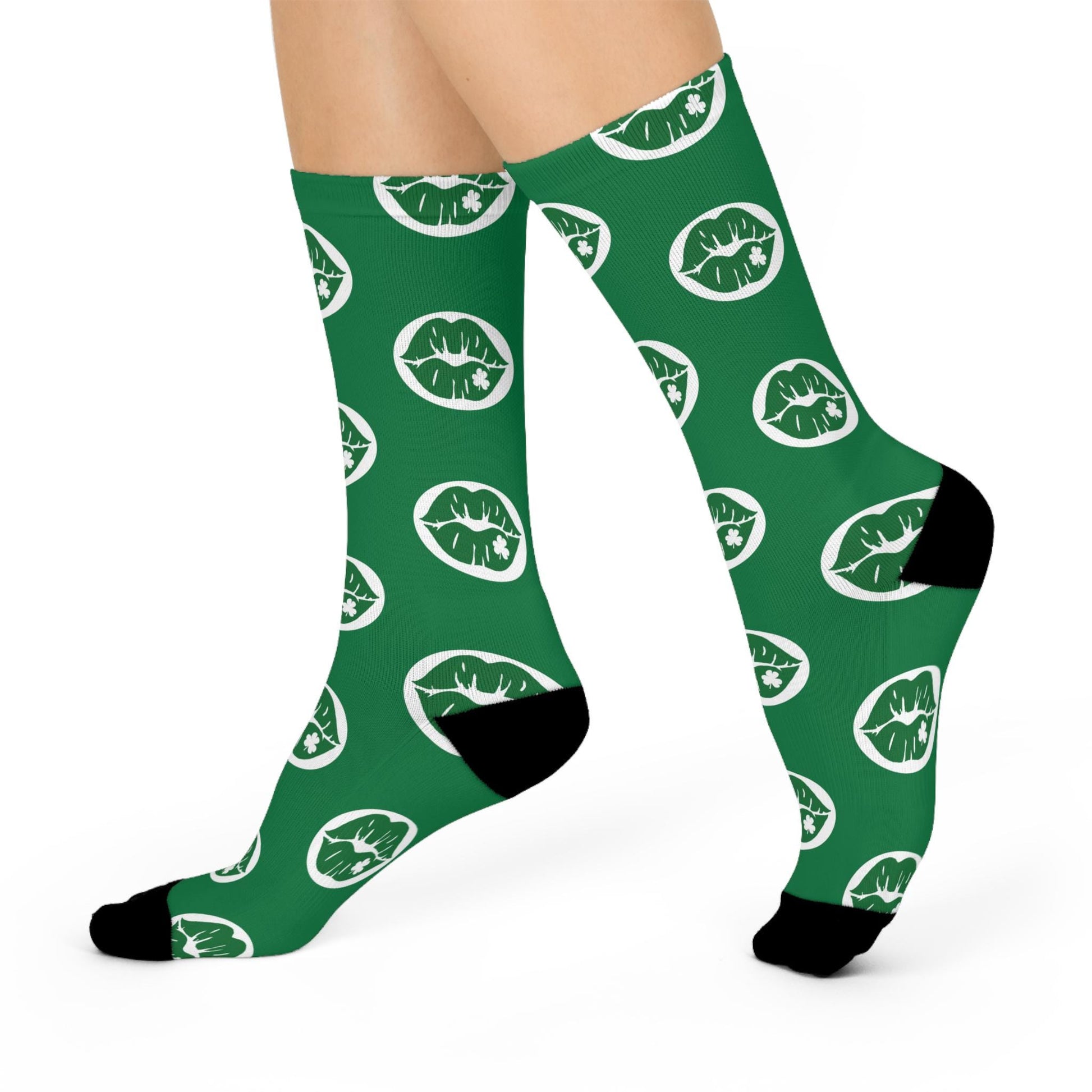 Green socks with white and green lips pattern worn by a person on a white background