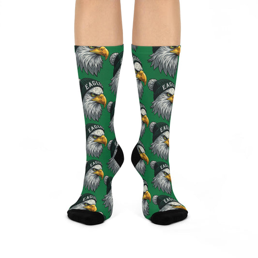 A pair of green cushioned crew socks with an all-over print of eagle designs.