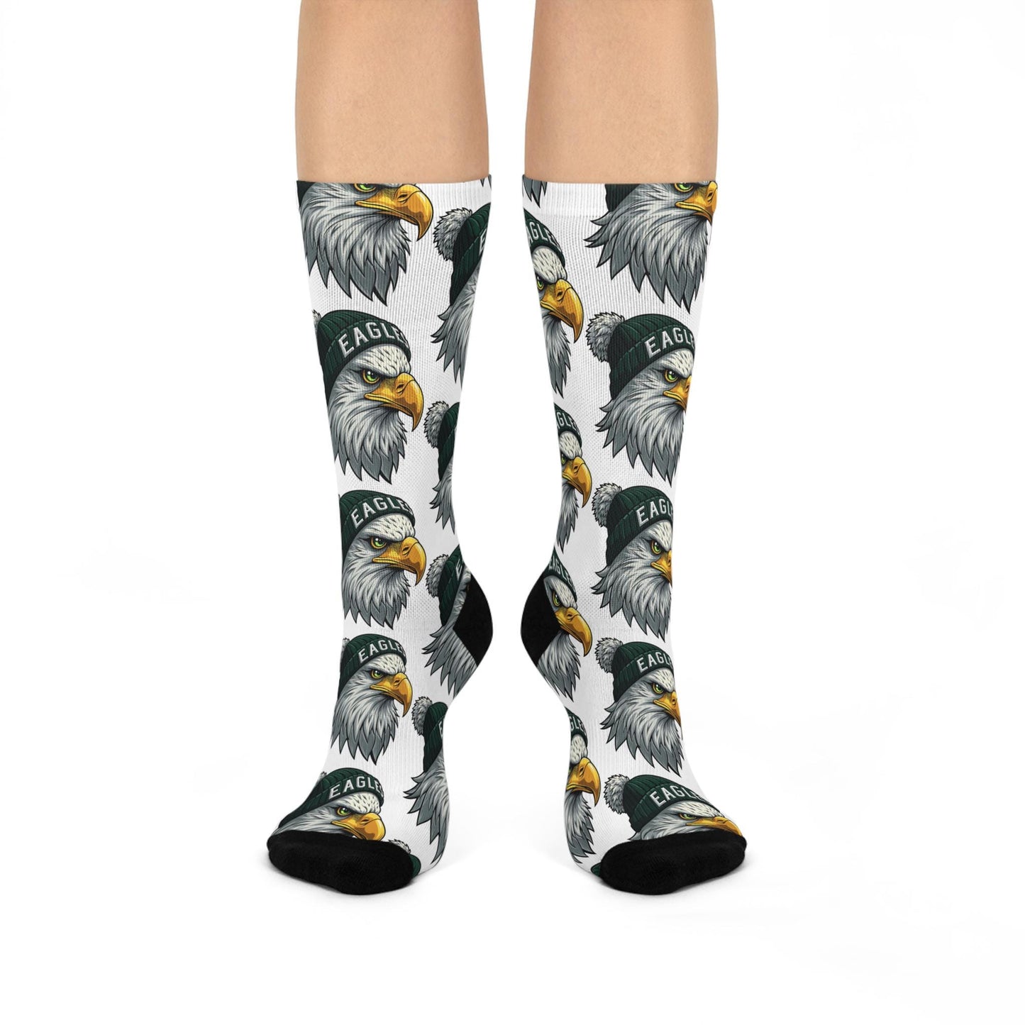 A pair of white cushioned crew socks with a pattern of eagle designs in grey and yellow colors.
