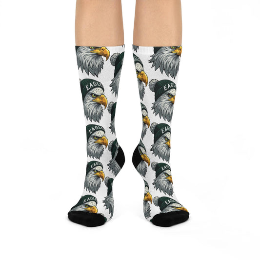 A pair of white cushioned crew socks with a pattern of eagle designs in grey and yellow colors.