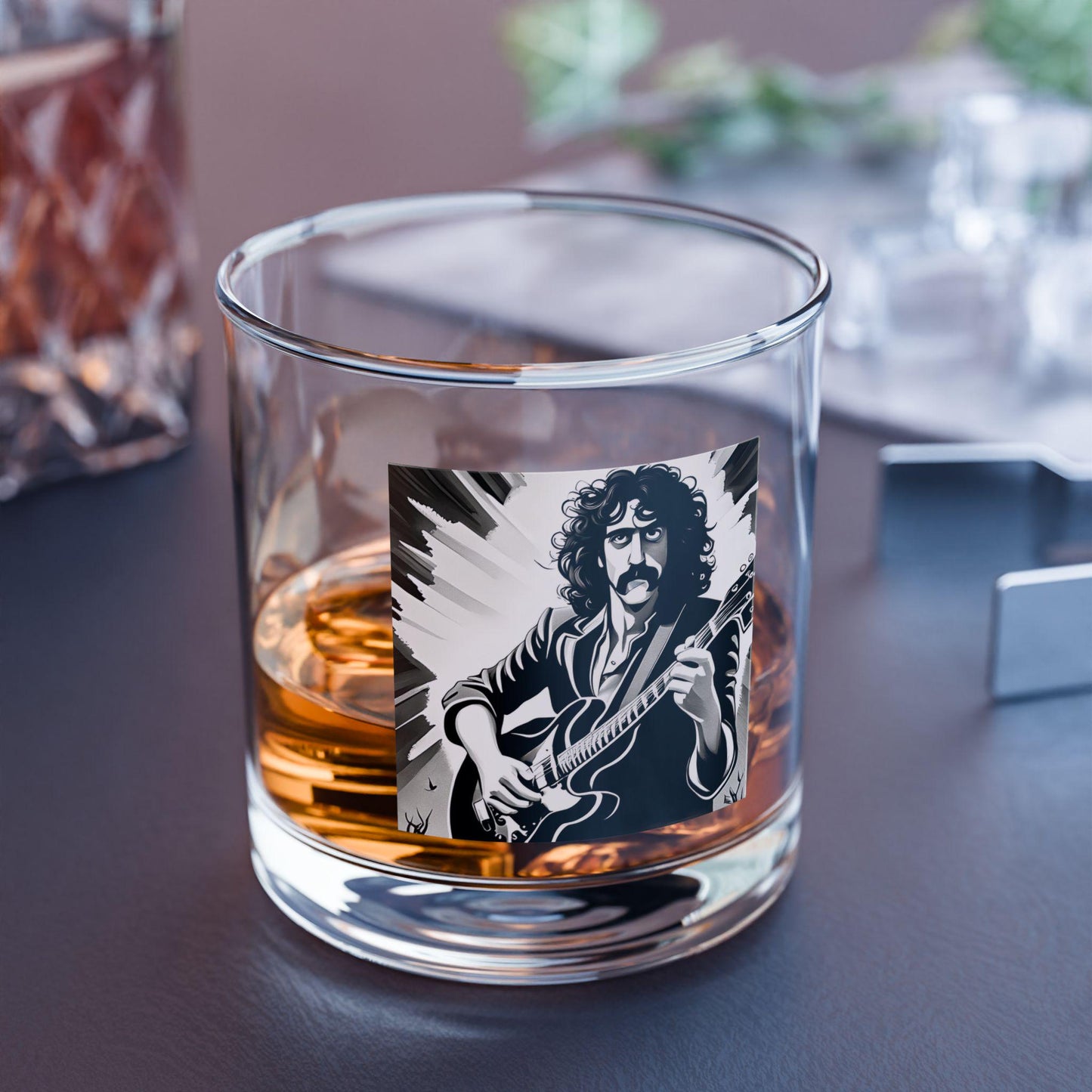 Glass with a guitar player illustration and whiskey inside on a dark surface