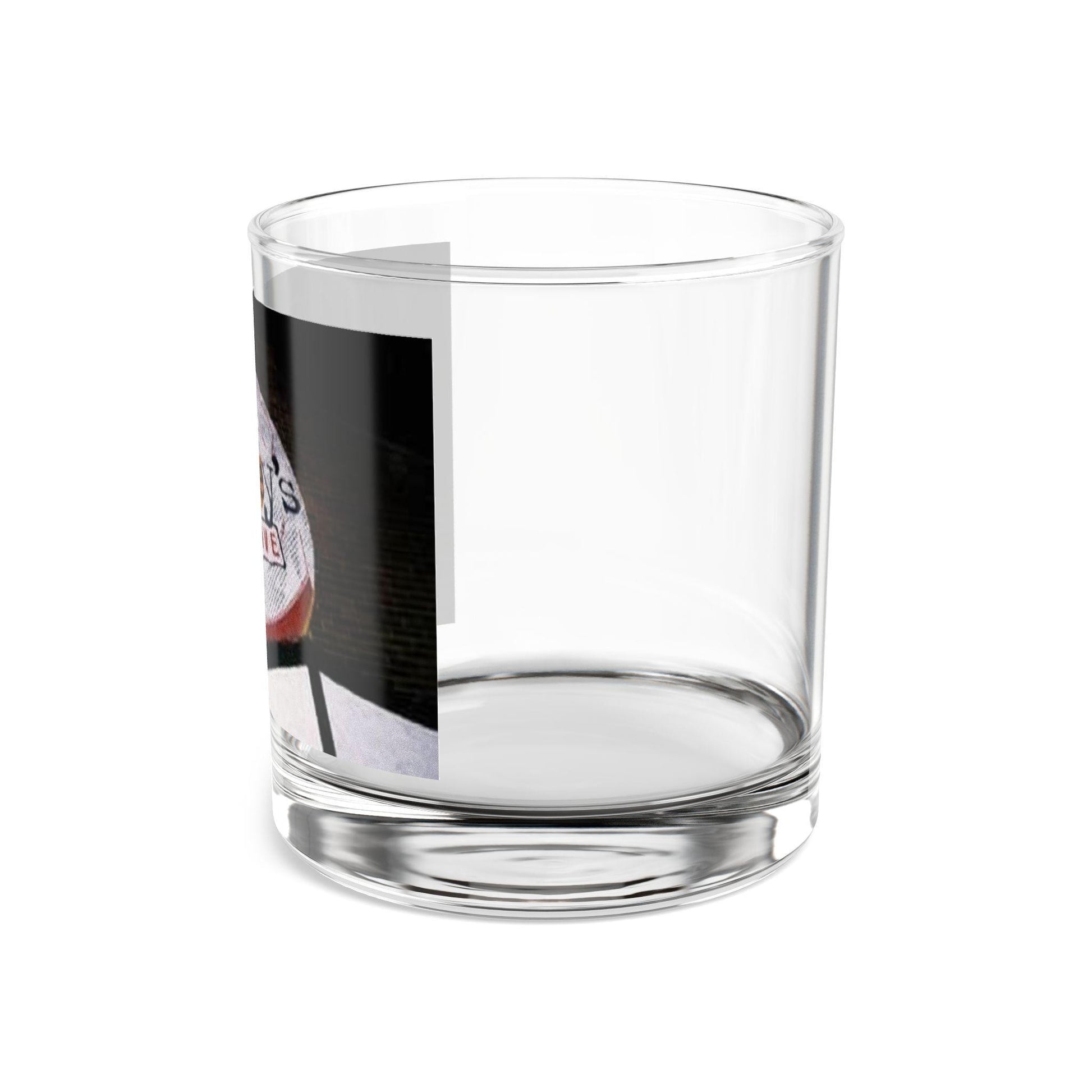 Clear glass tumbler with a printed label on a white background