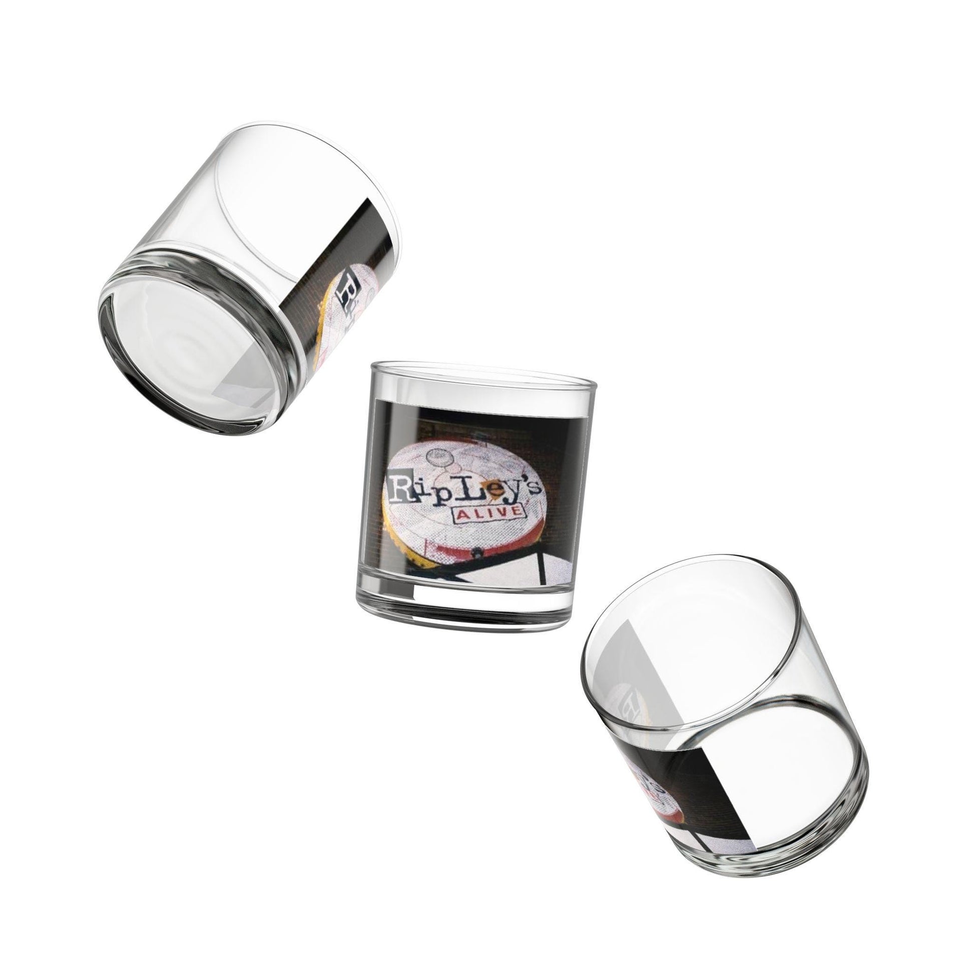 Three clear glass tumblers with printed designs on a white background