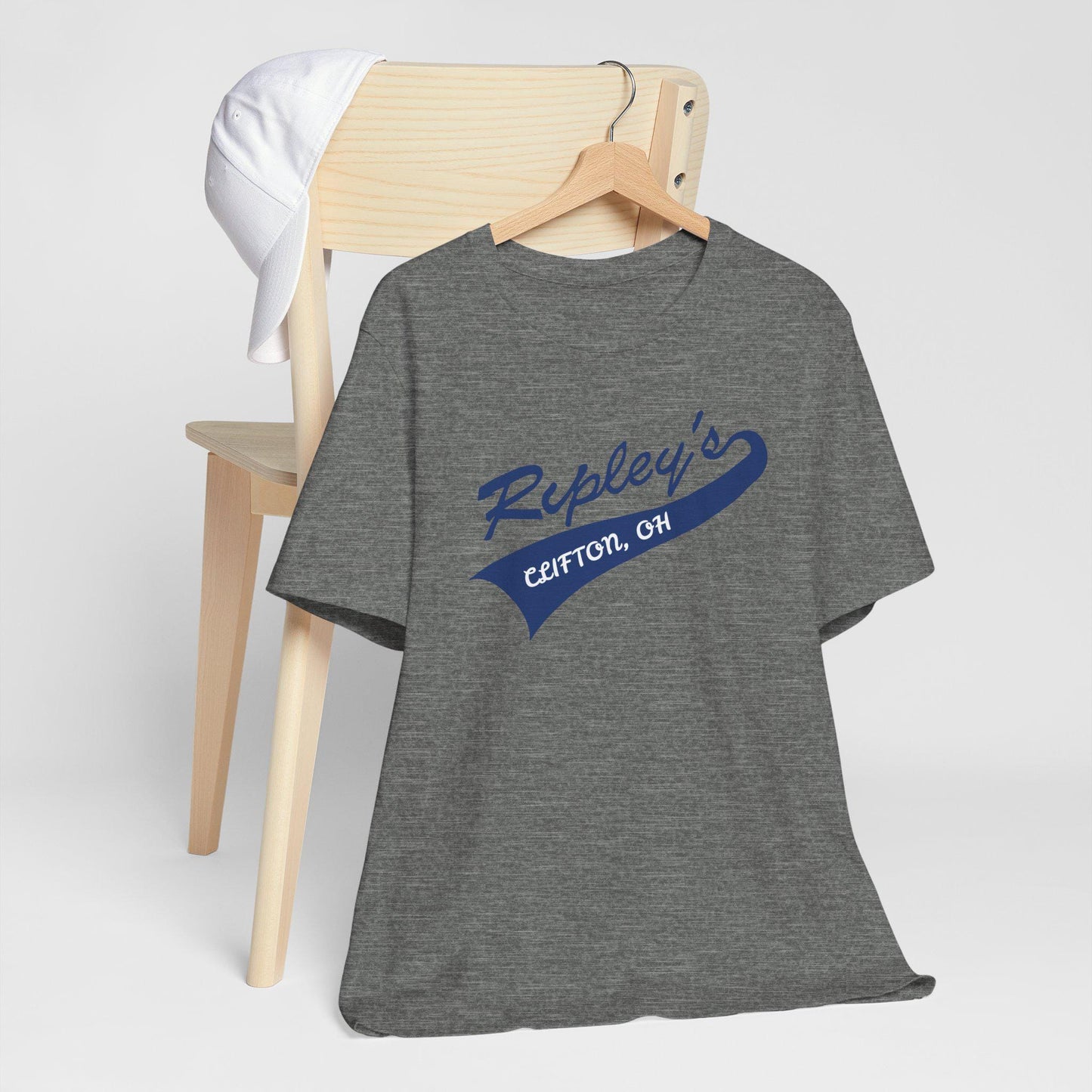 Gray t-shirt with blue text on a wooden hanger against a white background