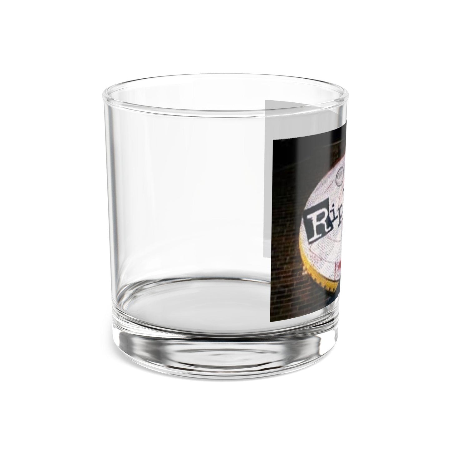 Clear glass tumbler with a printed label on a white background
