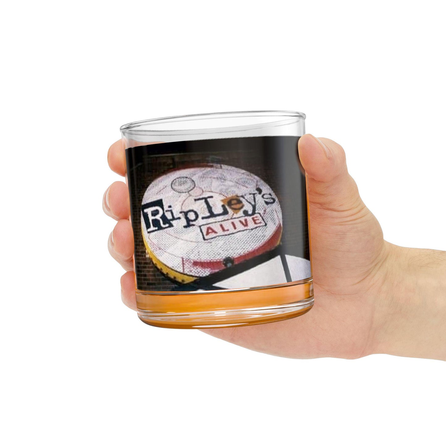Hand holding a glass with a Ripley's Alive label on a white background
